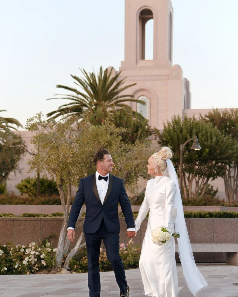 Couple walking from the Newport Beach Temple — wedding day